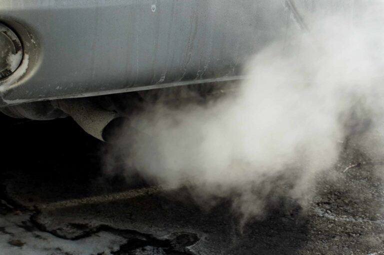 Exhaust of a car with white smoke coming out