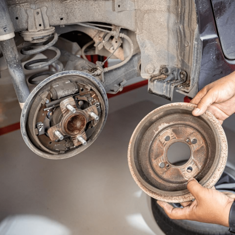 A mechanic inspecting a car brake system