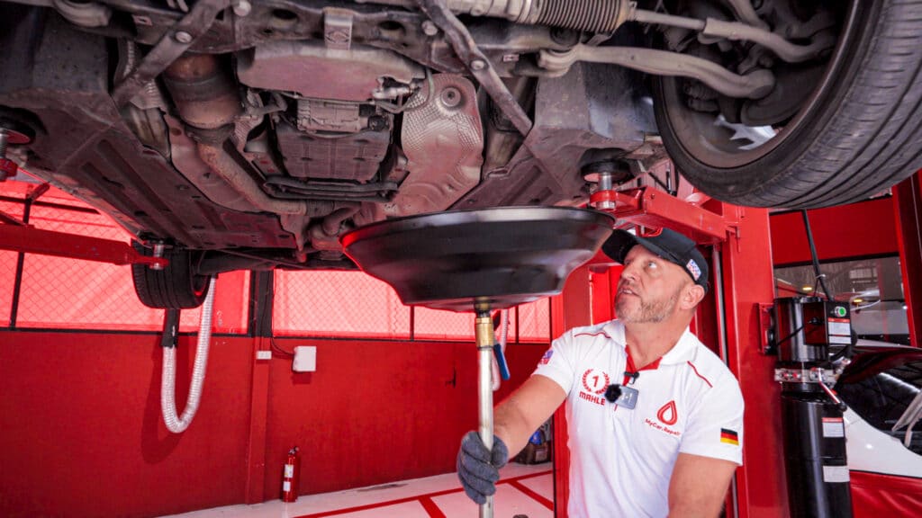 Placing the oil drain pan underneath Mercedes-Benz SLK200