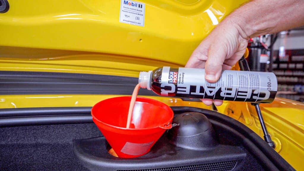 Pouring Liqui Moly Cera Tec into Porsche Boxster 981