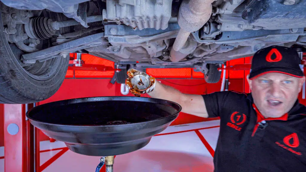 Unscrewing the oil filter by hand on Toyota Yaris