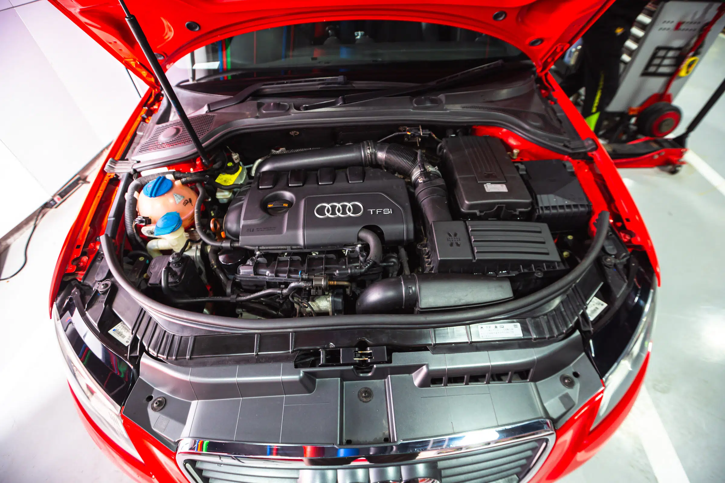 The open bonnet of an Audi A3 TFSI showing the engine compartment