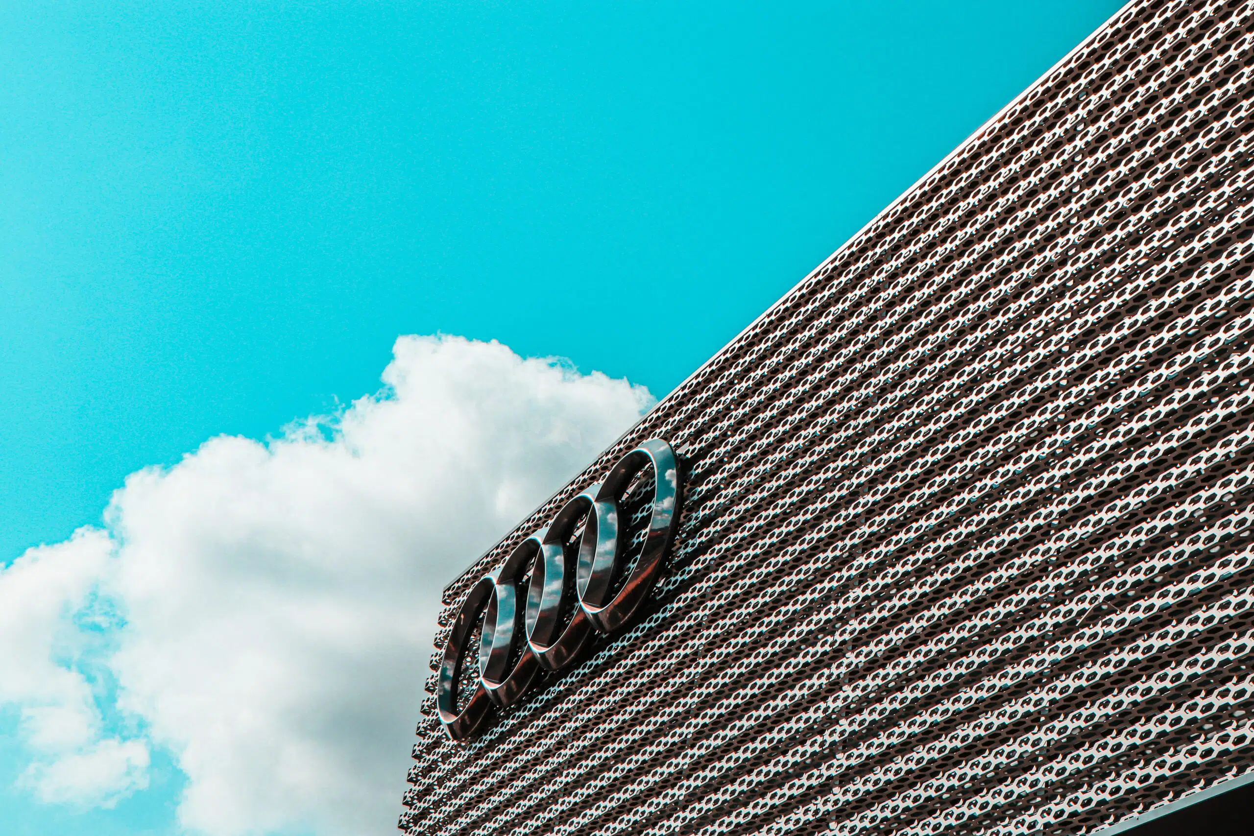 An Audi dealership with a blue sky background