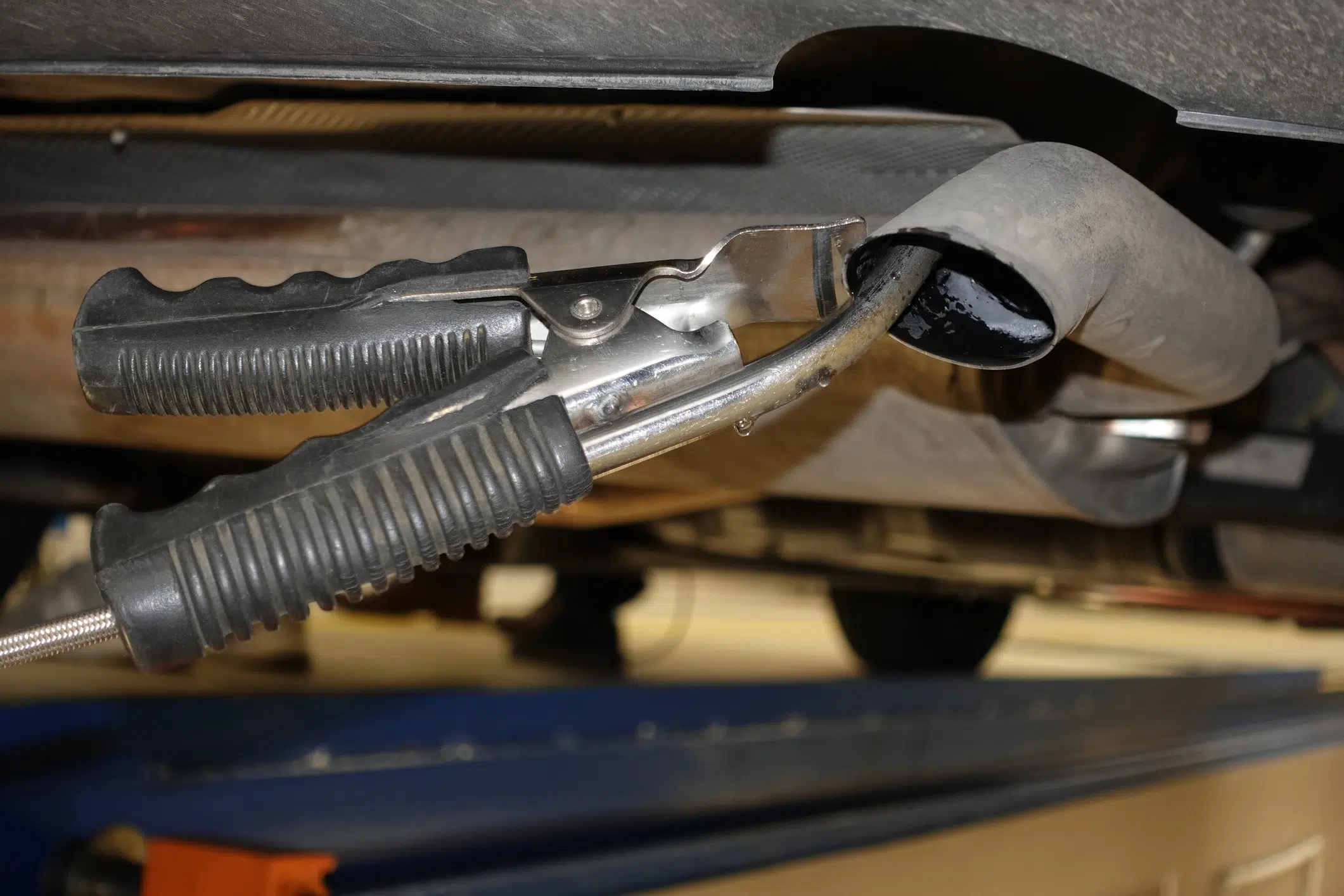 A car with a fuel filler cap and exhaust system
