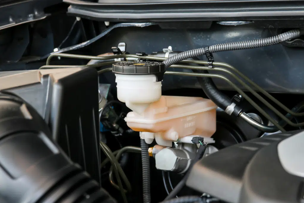 A mechanic checking power steering fluid issues